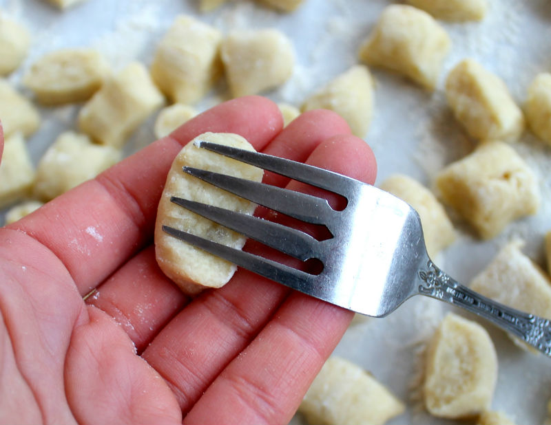 shape gnocchi with fork