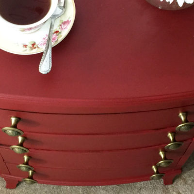 New hardware on red painted chest of drawers