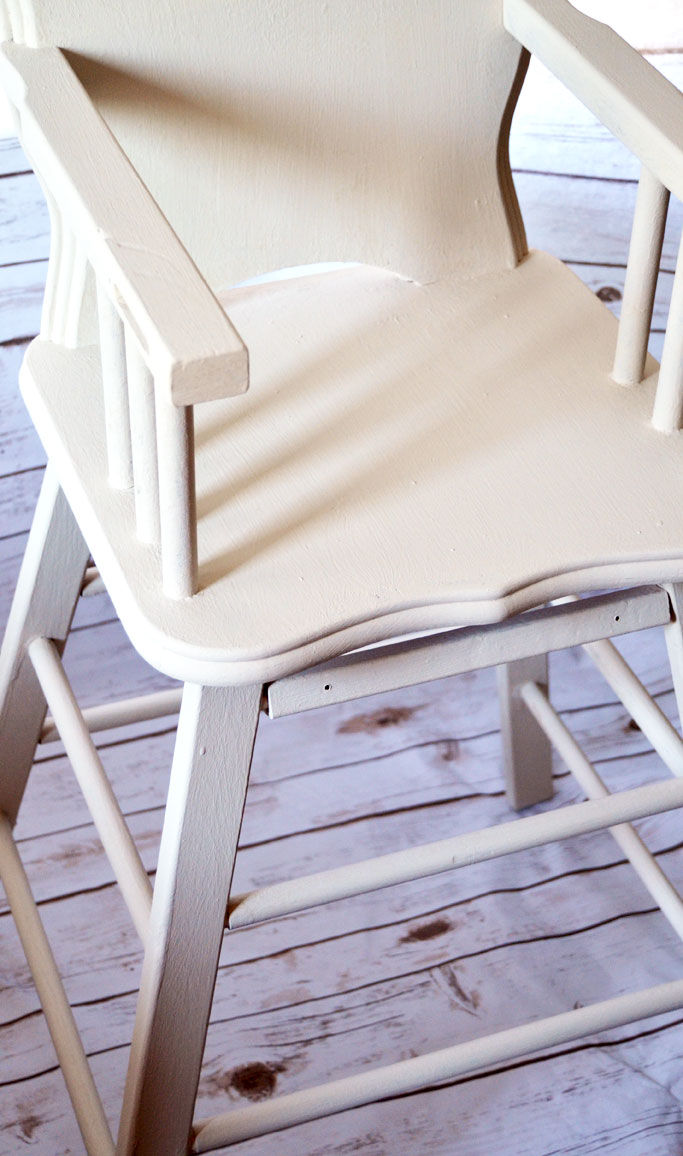 Old high chair restoration started with two coats of Amy Howard at Home One Step Paint in Linen