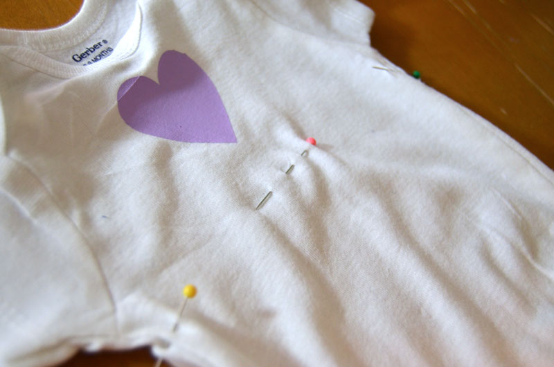 Use pins to mark placement of skirt of onesie dress