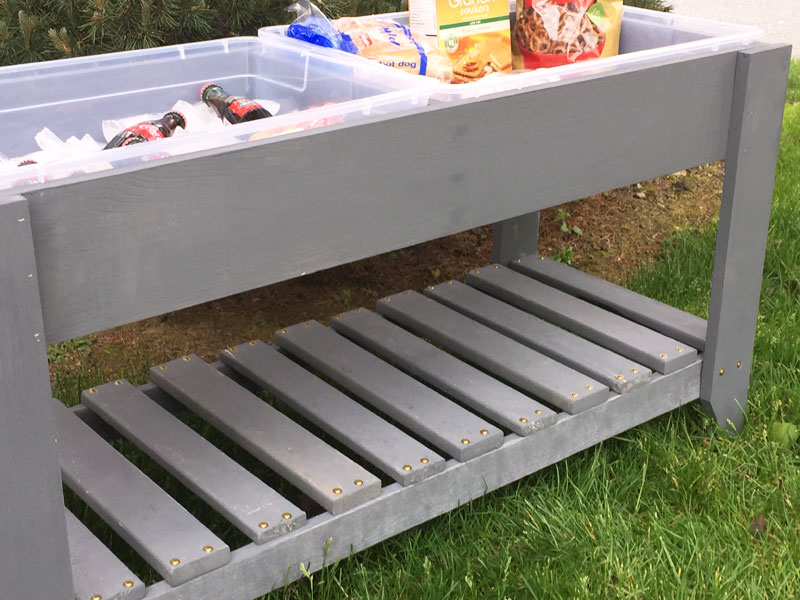 bottom shelf of outdoor serving table