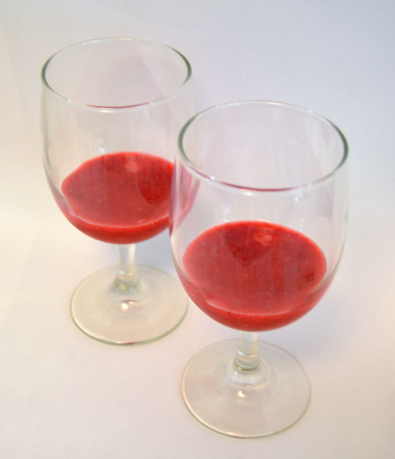 pour the puree into two glasses to make strawberry banana pina coladas