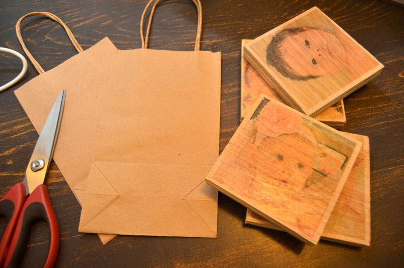 use paper bags with twine handles for use as hanger for photo blocks