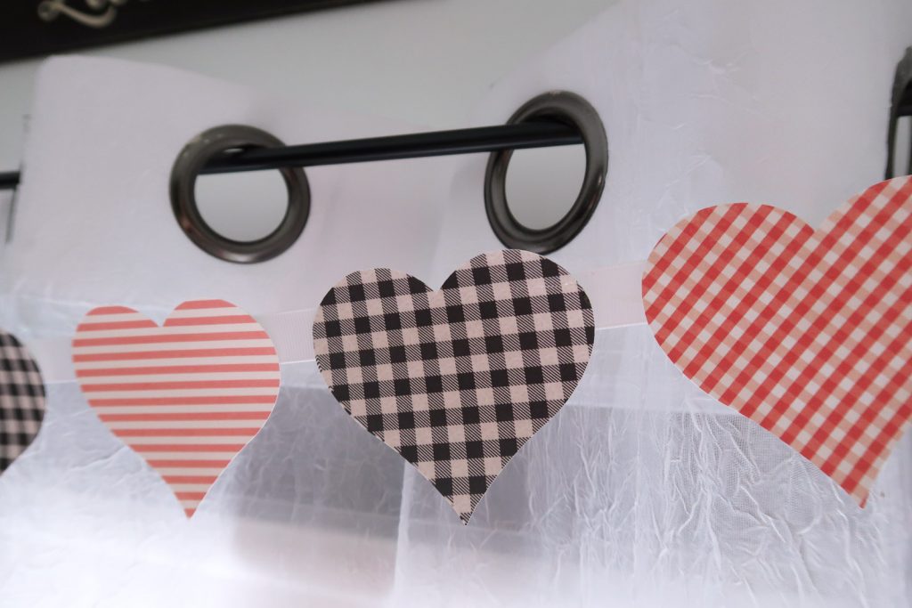 Print Then Cut Patterned Paper Heart Banner made with Cricut on curtain rod