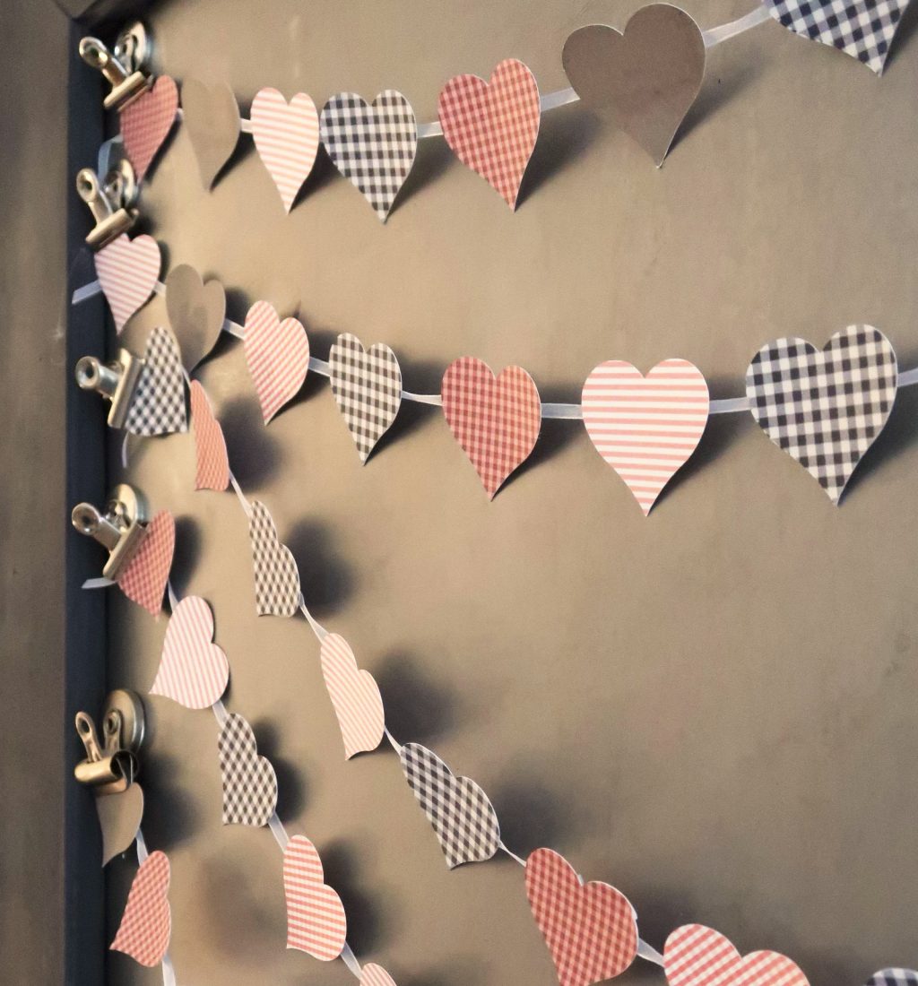 Print Then Cut Patterned Paper Heart Banner made with Cricut hanging on picture frame